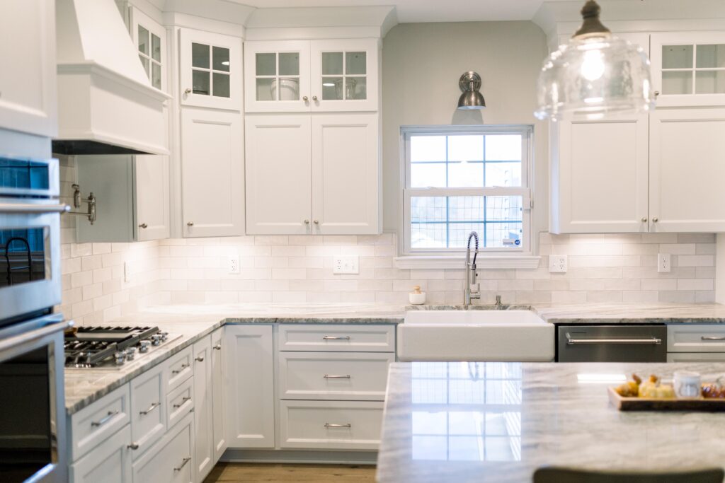 White Kitchen cabinets with ceramic tile backsplash. 